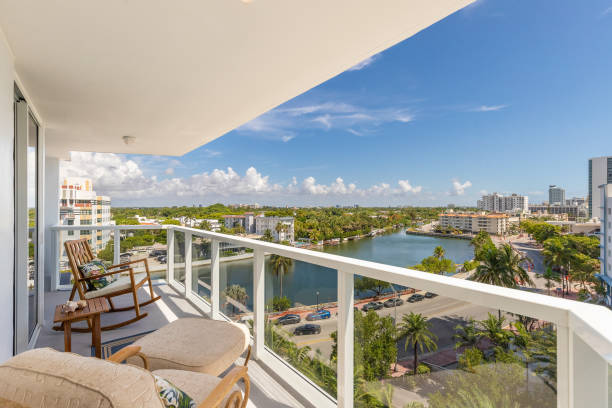 View of balcony in Mid-Beach in Miami Beach biscayne bay is observed, beach with the turquoise sea, modern buildings and towers, tropical and summer weather, blue sky with clouds